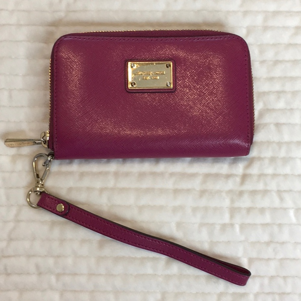 Michael Kors Wristlet, Size Small Plum color with Gold Hardware in EUC